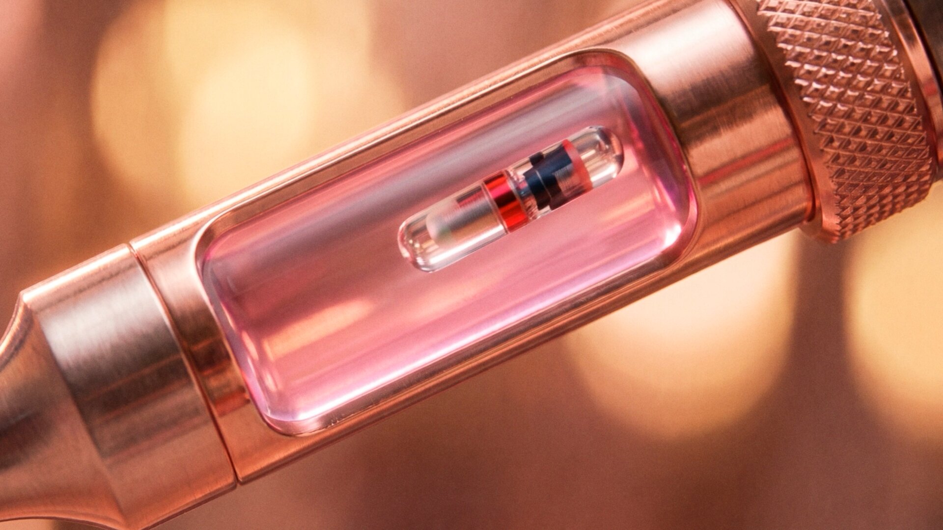 Macro of the PURE LOVE capsule inside the rosé applicator