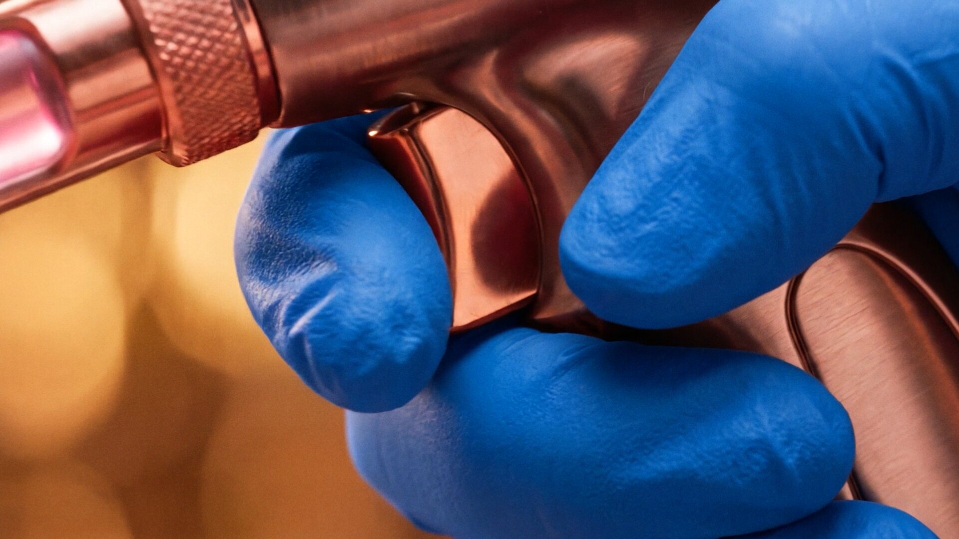 A gloved hand on the trigger of the rosé applicator